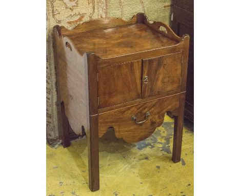 BEDSIDE COMMODE, George III mahogany with a wavy galleried back and two panelled doors above a drawer on square chamfered sup