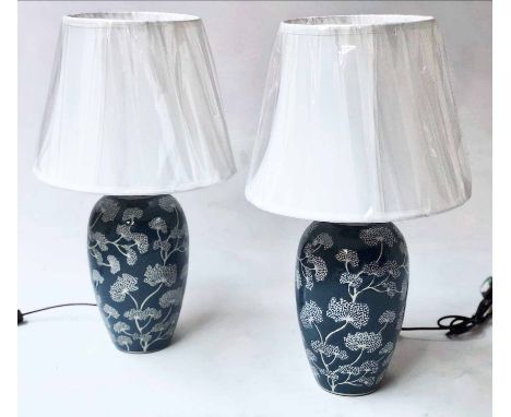 LAMPS, a pair Chinese ceramic blue and white foliate vase form with shades, 52cm H. (2)