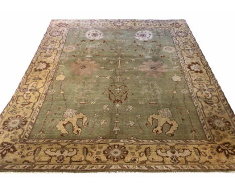 FINE OUSHAK CARPET, 295cm x 245cm, palmette and vine design on a jade field.