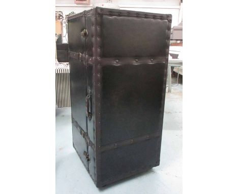 UPRIGHT BAR TRUNK, rectangular studded leather enclosing compartments and shelves on castors, 48cm W x 107cm H x 52cm D.