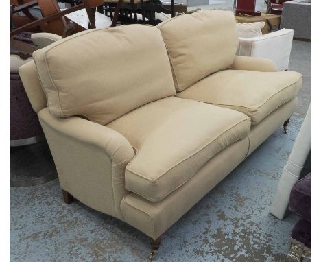 SOFA, two seater, Howard style in beige fabric on turned castor supports, 189cm L.