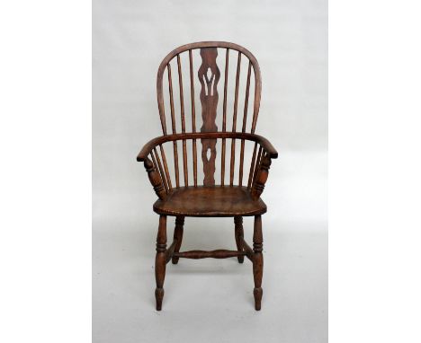 A 19th century ash and beech comb back Windsor armchair with carved splat