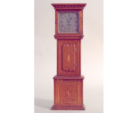 The movement of a 19th century pocket watch, converted to a miniature longcase clock, with silvered dial and Roman Numerals, 