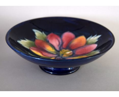 Moorcroft 'Clematis' pattern small shallow bowl raised in stand, navy blue ground, impressed marks to base, 16cmD together wi