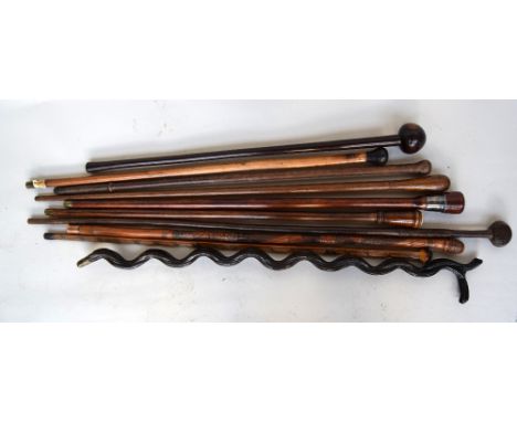 A selection of 19th and 20th century walking canes including a tribal club, a leather bound cane, a cane with bulbous finial,