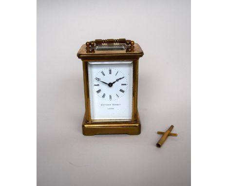 An early 20th century brass cased carriage clock, signed Matthew Norman London, enamel dial with Roman numerals, bevelled gla
