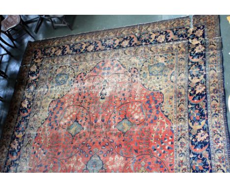 A large Tabriz carpet, with red, cream and blue fields, multiple floral borders, large central medallion surrounded by scroll