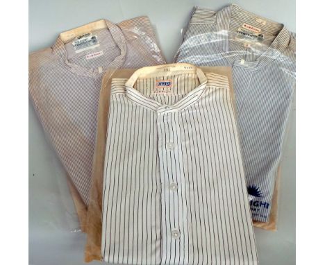 Three vintage white pinstripe collarless shirts.  In laundry bags although all are age discoloured. (3)