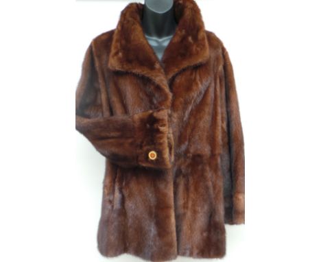 A fitted mink jacket circa 1960's with single lapels and button details to cuffs. Very nice condition - approx size 12 - 14