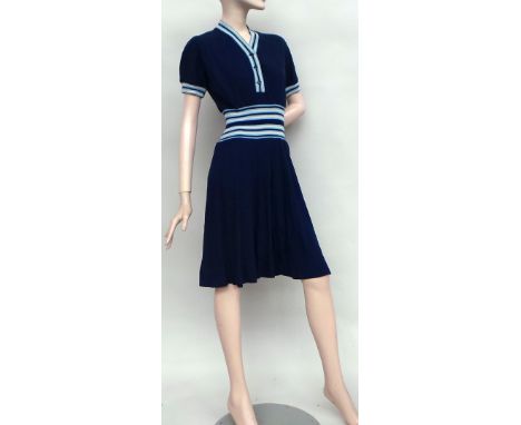 A 1940's Jaeger wool dress in navy with cream and blue stripes to neckline cuffs and waist - one or two small holes otherwise