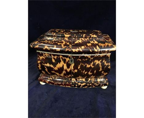 An Antique Tortoiseshell tea caddy with a musical box in the lid