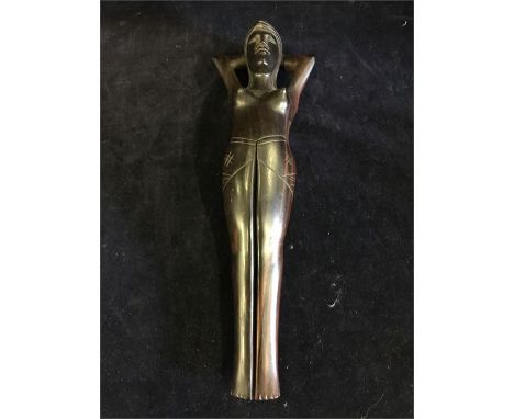African carved nut cracker in the form a reclining nude.