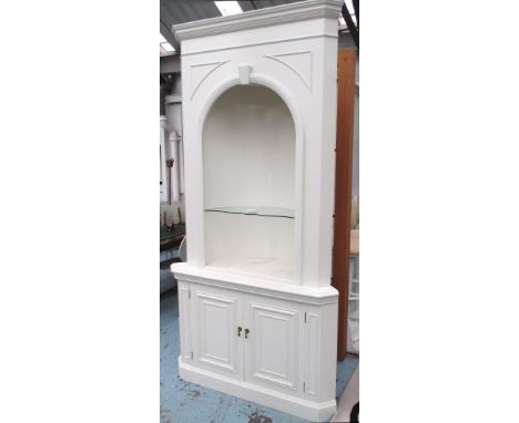 CORNER CABINET, cream painted the upper section with a shaped glass shelf on a base with a pair of panelled doors, 126cm x 24