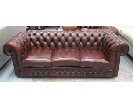 CHESTERFIELD SOFA, burgundy leather three seater with cushion seat and castors, 204cm W.