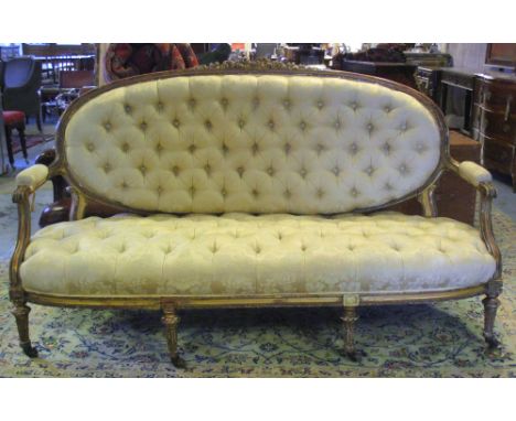 SOFA, Victorian giltwood, in the French taste, with buttoned cream Damask upholstery, on fluted legs and castors, 182cm W (wi