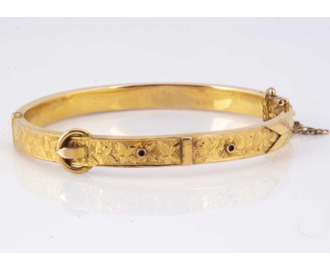 A Victorian 9ct gold buckle bangle, the engraved ivy leaf top section with buckle design, with tongue and box clasp now af, 5