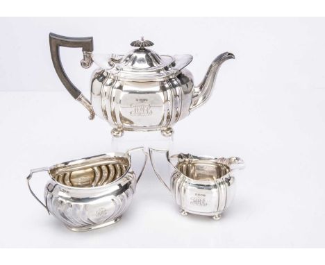A harlequin Edwardian silver three piece teaset, the teapot and milk jug by Charles Boynton & Sons and the sugar basin by HA,