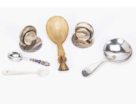 Four small silver items and two other items, including a pair of silver menu holders a Victorian silver caddy spoon, a silver