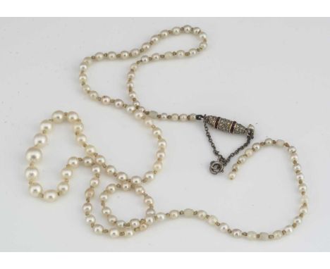 A string of graduated cultured pearls, knotted strung supported on an antique ruby and diamond barrel clasp (af), 11.9g