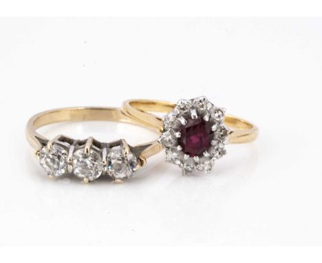 Two 9ct gold dress rings, including a ruby and diamond cluster, ring size L and a three stone white sapphire dress ring, ring