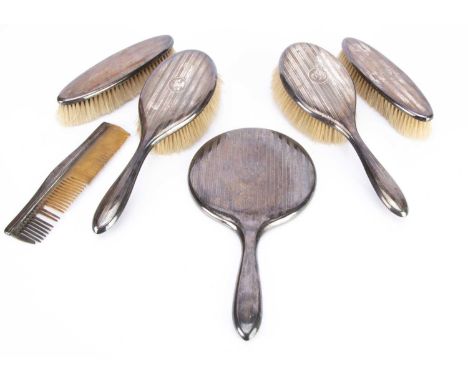 A George V silver six piece dressing table set by W & FB, including a pair of hair and clothes brushes, a comb, AF, and a han