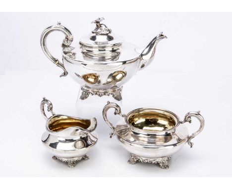 An 1830s silver three piece tea set by WB, possibly William Bateman, the teapot with flower and leaf finial and having ivory 