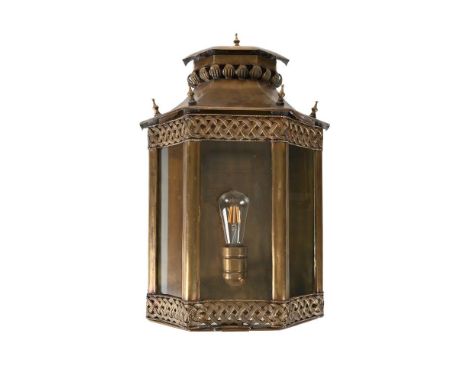 A LARGE MOROCCAN BRASS WALL LANTERN  CIRCA 1940  Of trapezoid form, with hinged door to the lower section recently converted 
