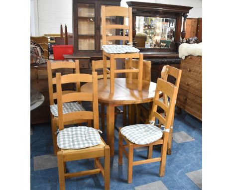 A Mid 20th Century Circular Kitchen Extending Dining Table with Two Extra Leaves and a Set of Six Matching Rush Seated Ladder