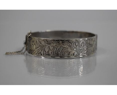 A Silver Hinged Bangle, Engraved Foliate Decoration to Front Panel, Internal Diameter at Widest Point 61mm, Birmingham 1963, 