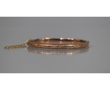 A 9ct Rose Gold Hinged Bangle with Engraved Scrolling Decoration, Birmingham 1902, Makers Mark Rubbed, Safety Chain Present, 