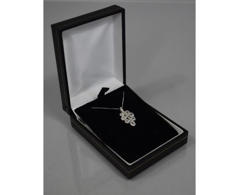 A 9ct Gold and Diamond Set Pendant on a Fine 14ct Gold Chain, Celtic Knot Design with Approx 37 Diamond Chips. Total Weight 2