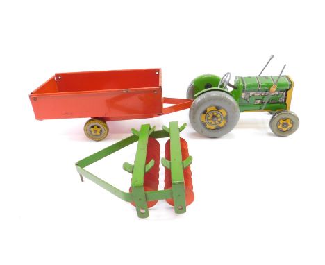 A Mettoy tin plate tractor, with a trailer and a scarifier. (3)