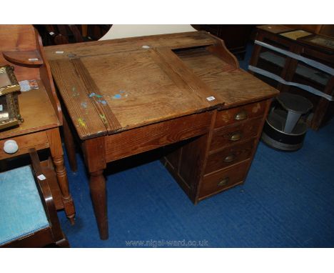 Pitch pine clerks desk with double inkwell and four drawer pedestal.