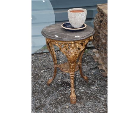 Cast iron pub table on paw and claw feet 20" diameter, plus garden pot etc.