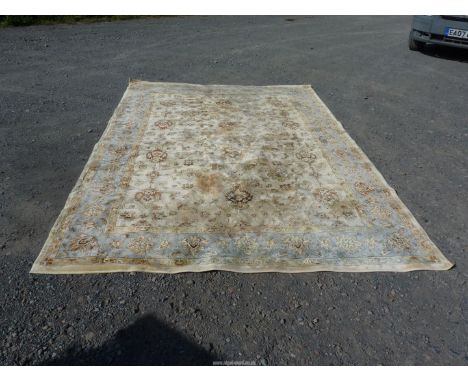 A bordered and patterned beige ground Carpet with blue and green border, in all over floral pattern, 92 1/2" x 133 1/4" (some