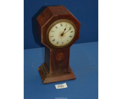 A wooden mantle clock with octagonal shaped case to the face with key 10" ( in working order).