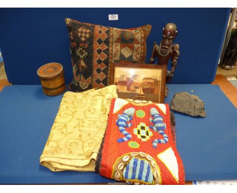 A quantity of miscellaneous to include: a carpet cushion, beaded wall hanging with masks and gecko decoration, a wooden triba