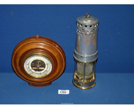 A Davis 'Derby Boss' lamp and an aneroid barometer.