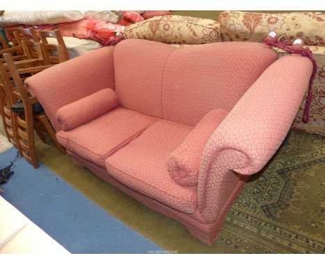 A deep dusky pink lattice patterned upholstered Knoll style two seater Settee with tasselled rope back supports and two roll 