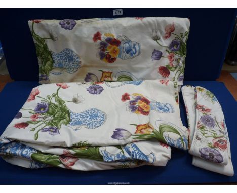 A pair of Curtains with blue and white jugs and floral sprays pattern, with matching tie backs, 100" wide x 79" drop.