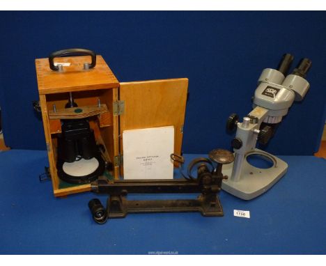 A wooden cased USSR made Binocular Microscope, a Kyowa Tokyo No 832702 bench microscope and an old stapler.