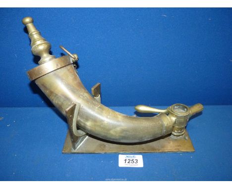 A large horn Powder Flask with brass mounts and stand.