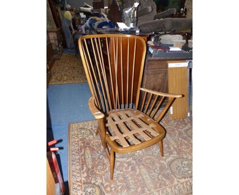 An Ercol stickback Armchair frame (cushions not fireproof and not included).