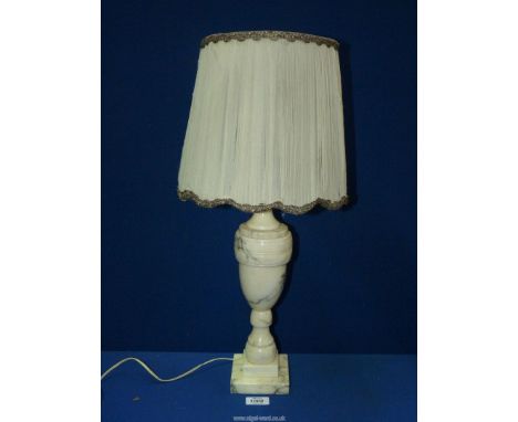 An Alabaster table lamp having silk shade with metallic threading to edges, 22 1/2" tall overall including shade.