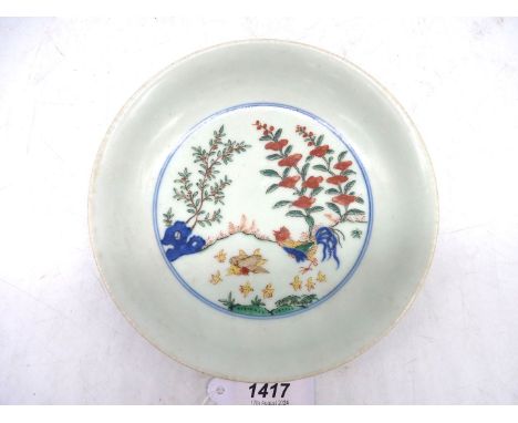 A fine early Chinese plate, circa 1700, decorated in the famille vert pallete, Kangxi period with the imperial mark of Wanli;