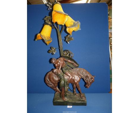 A three branch table lamp with an armed man on horse back saying goodbye to loved ones with orange and blue mottled glass sha