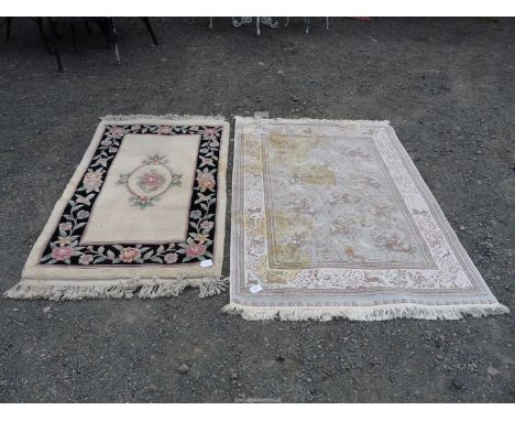 Two border patterned and fringed rugs, one 'bamboo silk' in pale silver grey colours with hunting scenes, (rug with stains), 
