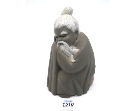 A Lladro figure of a seated resting Chinaman, in grey matt finish, 6 1/2" tall.