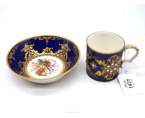 A Sevres coffee can and a saucer, 5 1/2" diameter, with jeweled decoration on blue nouveau ground, interlaced L marks to both