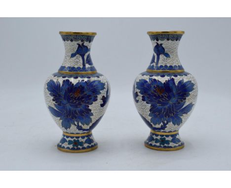 A pair of Japanese cloisonné vases with blue birds amongst foliage on a white background. 16cm tall. Generally in good condit